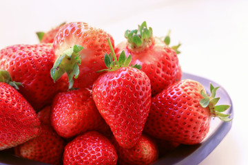 Fresh strawberries in bowl on white background