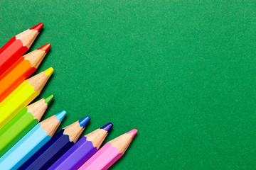 colorful pencil on green background
