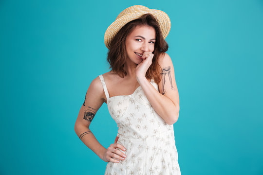 Porrtrait of a smiling playful shy woman wearing summer clothes
