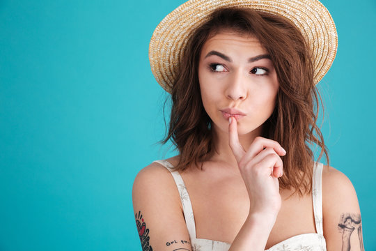 Thoughtful Young Woman In Straw Hat Wondering And Looking Away