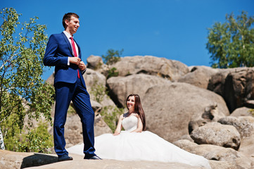 Lovely wedding couple at amazing landscapes with rock Dovbush, Carpathian mountains at Ukraine.