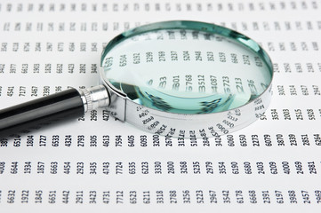 magnifying glass and document with figures