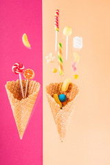 Close-up top view of waffle cones and mix of delicious candies
