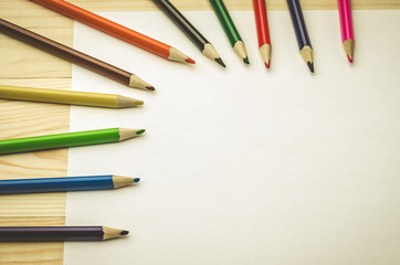 paper with colored pencils/sheet of paper with colored pencils