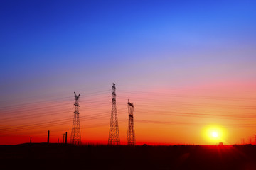 Fototapeta premium High voltage towers, under the setting sun