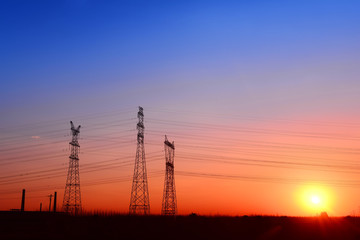 High voltage towers, under the setting sun