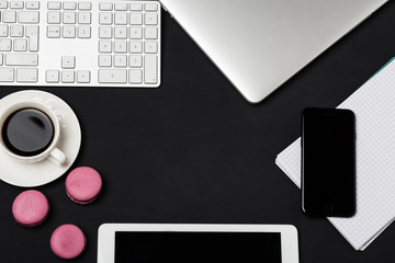 Office workplace with text space. Top view of office dark desk table with laptop, phone, tablet,...