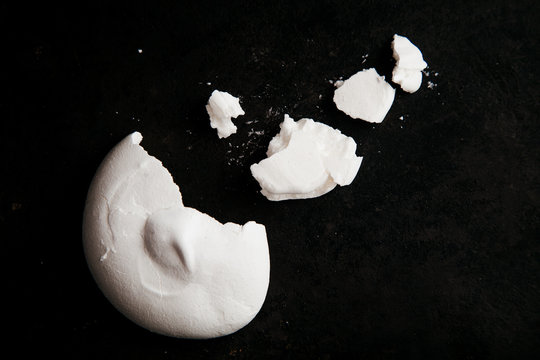 French Meringue Crumbs On Black Background With Text Space