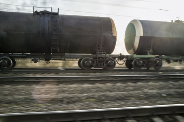 Panning a freight train on the railway in the spring evening, at sunset