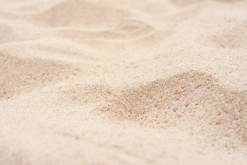 Fototapeta na wymiar Yellow sand on the beach on a summer day. Close-up.