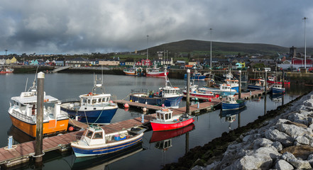 Various types of boats docked in Dingle bay harbour on the wild atlantic way in County Kerry, Ireland