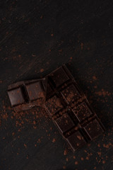 Dark chocolate bar covered with chocolate powder