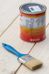 Painting brush with paint bucket on the wooden boards
