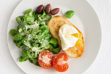corn salad dressed with olive oil and lemon juice sprinkled with parmesan,  poached egg toast, fresh tomato, and kalamata olives