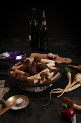  still llife with raw morels on the dark background