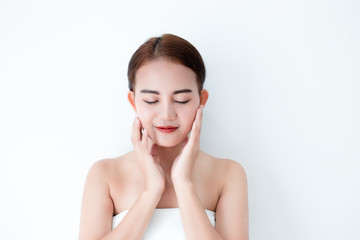 Closeup portrait of asian woman touching face skincare on white background