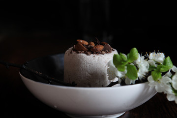 Paskha is a festive dish made in Eastern Orthodox countries. Curd Easter and bunch of flower in close up on the dark background 