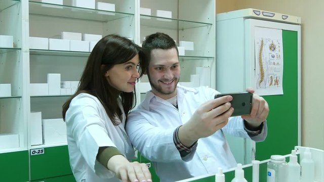 Funny team of pharmacist making selfie pictures at pharmacy