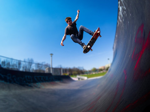 Skateboarder doing ollie on ramp