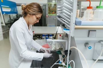 Laboratory technician in lab cleaning object