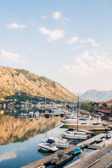 Fototapeta na wymiar Sailboat mooored in the marina of Kotor village on Kotor Bay