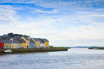 Irish coastal landscape with the typical colored fishermen's houses with sloping roofs (Galway -...