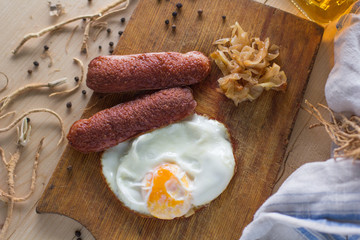 fried eggs with sausages and fried cabbage