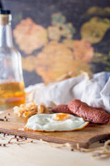 fried eggs with sausages and fried cabbage