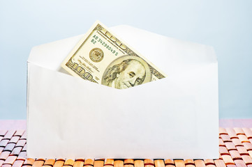 Hundred dollar bills in an envelope
