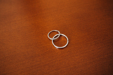 Gold wedding rings on a wooden background