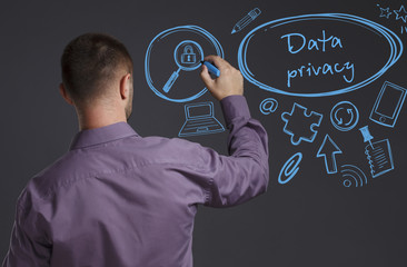 Business, Technology, Internet and network concept. A young businessman writes on the blackboard the word: Data privacy