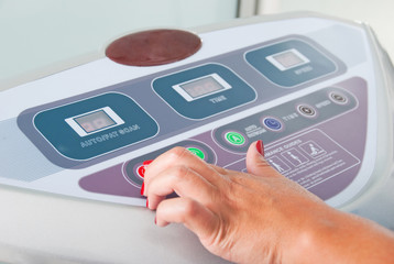 Close-up hand woman in control panel machine