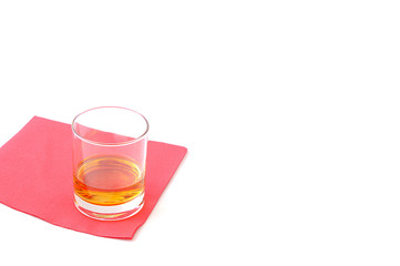 Alcoholic drink on a red paper napkin, isolated on white