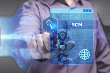 Business, Technology, Internet and network concept. Young businessman working on a virtual screen of the future and sees the inscription: SCM