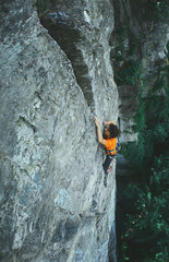 male rock climber on the cliff. man climber climbs on a rocky wall.