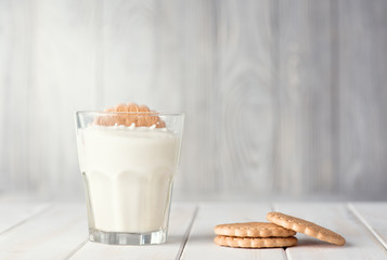 Milk and cookies on a white table