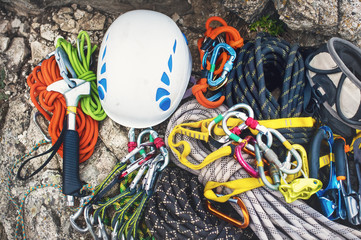 Used climbing equipment - carabiner without scratches, climbing hammer, white helmet and...