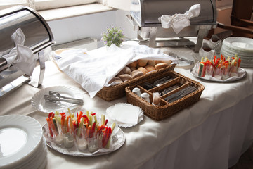 Catering. A bread basket with Cutlery and snacks for cocktail parties