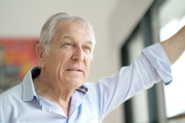 Senior man looking by window