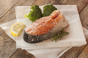 salmon raw. salmon red fish steak with herbs and lemon isolated on a white background