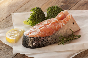 salmon raw. salmon red fish steak with herbs and lemon isolated on a white background