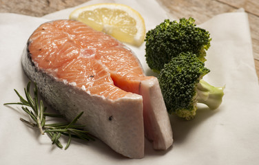 salmon raw. salmon red fish steak with herbs and lemon isolated on a white background