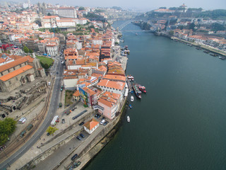 Panoramic view of the old city of Porto. One flew over the roofs of the houses, a river and a bridge.