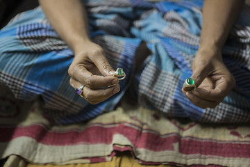 Indian Jeweler making an Oriental Jewelry in workshop.