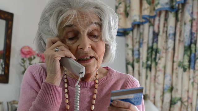 Senior Woman Giving Credit Card Details On The Phone
