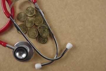 Red stethescope on wooden background. Medical and health care concept.