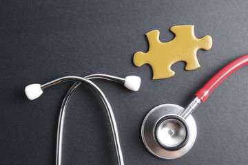 Red stethoscope,keyboard ,puzzle and coins. Medical concept.