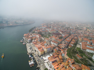 Obraz premium Panoramic view of the old city of Porto. One flew over the roofs of the houses, a river and a bridge.
