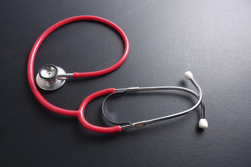 Red stethoscope,keyboard ,puzzle and coins. Medical concept.