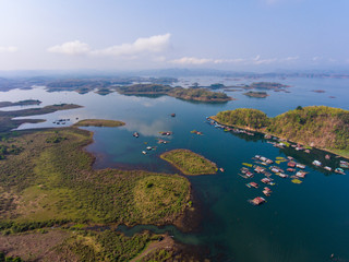 Aerial view of Village and fish farm among lake and mountain.